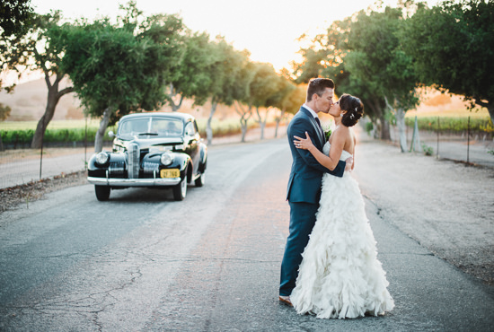 Bride and groom at sunset with a classic car after their Santa Ynez wedding at Firestone Vineyards